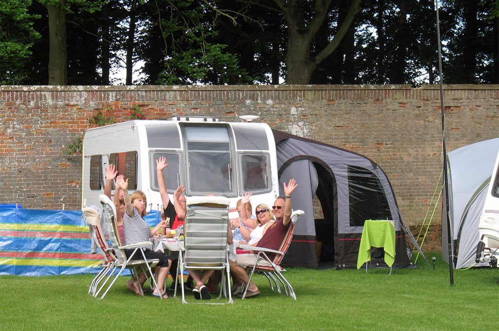 Families having a meal together at the campsite